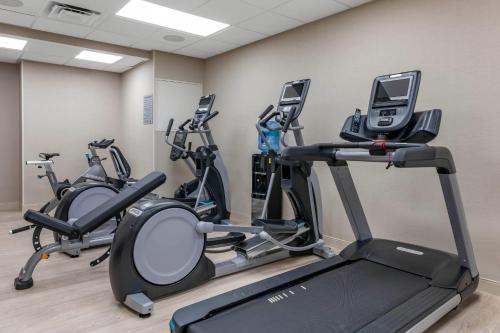 a gym with three exercise bikes in a room at Cambria Hotel St Petersburg-Madeira Beach Marina in St Pete Beach