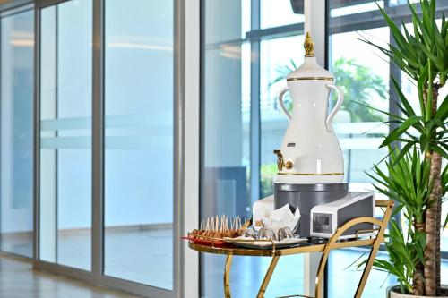 a food processor on a table with a plate of food at Clarion Hotel Jeddah Airport in Jeddah