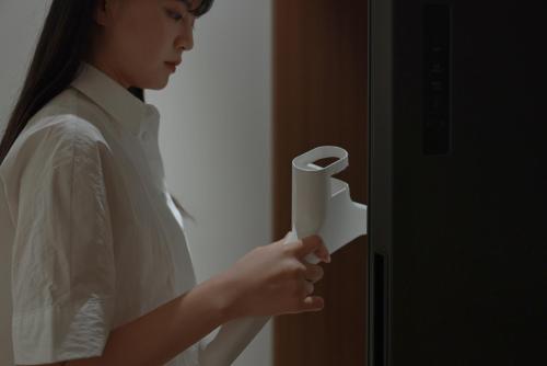 a woman holding a wii remote in her hand at Aank Ryokan Hotel Ansan Seonbu Branch in Ansan