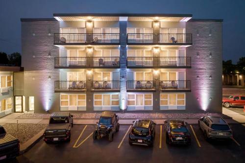 a group of cars parked in a parking lot in front of a building at Clarion Pointe Rhinelander Downtown in Rhinelander