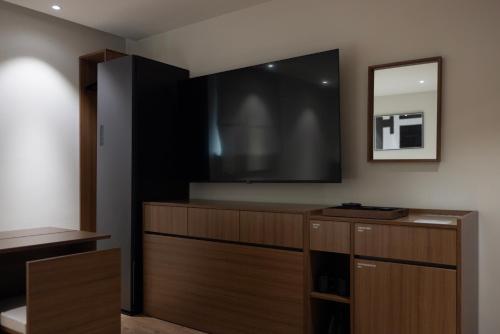 a living room with a large flat screen tv at Aank Ryokan Hotel Ansan Seonbu Branch in Ansan