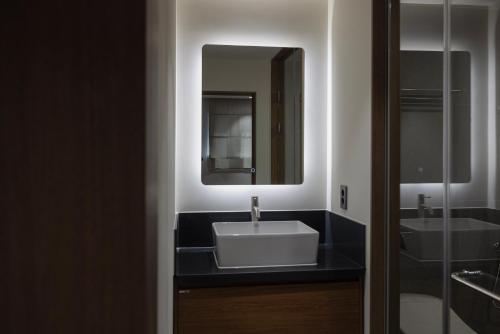 a bathroom with a sink and a mirror at Aank Ryokan Hotel Ansan Seonbu Branch in Ansan