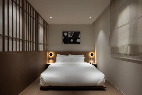 a bedroom with a large white bed and a window at Aank Ryokan Hotel Ansan Seonbu Branch in Ansan