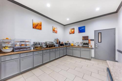 a kitchen with gray cabinets and a counter top at Comfort Inn & Suites in Schulenburg