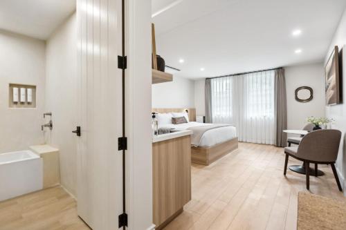 a bedroom with a bed and a desk with a chair at Casa Riviera - Boutique Suites in Downtown Santa Barbara in Santa Barbara