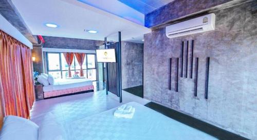 a room with a bedroom with a bed and a air conditioner at Ps Extra Hotel in Hat Yai
