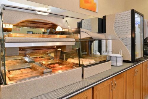 a restaurant kitchen with a buffet of food at Quality Inn & Suites Jefferson City in Jefferson City