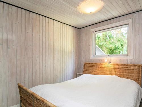 a bedroom with a bed and a window at 5 person holiday home in Tranekær-By Traum in Tranekær