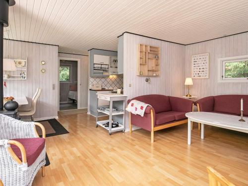 a living room with two couches and a table at 5 person holiday home in Tranekær-By Traum in Tranekær