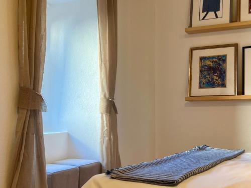 a bedroom with a bed and a window with a blanket at Medieval Beachside Retreat in Risan