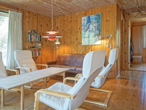 a living room with a table and chairs at 6 person holiday home in Nexø in Vester Sømarken