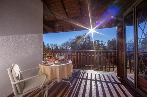 a table on the deck of a house at Villa La Verbanina Private Garden - Happy Rentals in Ghiffa