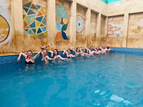 a group of people swimming in a swimming pool at Hotel Tokyo Palace in Jaisalmer