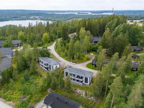 an aerial view of a house in the woods with a lake at Peaceful 2BR Getaway Cabin at the Top of Riihivuori in Muurame