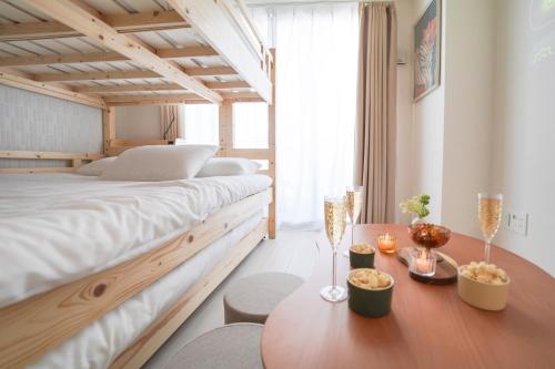 a bedroom with a large bed and a wooden table at Encounter Ohori403 in Fukuoka