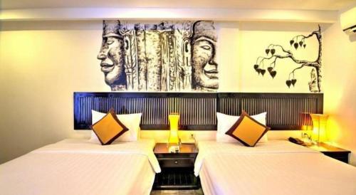 Postel nebo postele na pokoji v ubytování La Residence Blanc D' Angkor