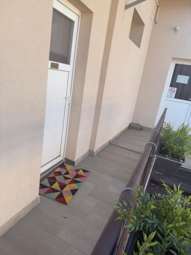 a door with a colorful floor in front of a building at Benvenuto Apartman in Budapest