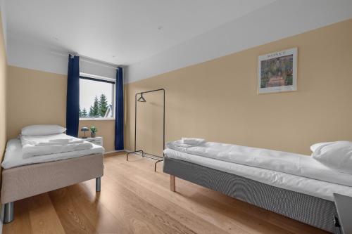 a room with two beds and a mirror at Unique Family House Near the Arctic Cathedral in Tromsø