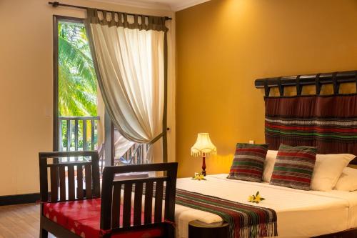 a bedroom with two beds and a window at Seahorse Resort & Spa in Mui Ne