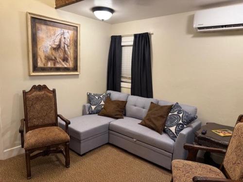 a living room with a couch and a chair at Cozy Country Easy Peasy in Fredonia