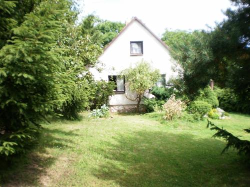 a small white house in the middle of a yard at Outdoor Adventure & Relaxation in Svinařov