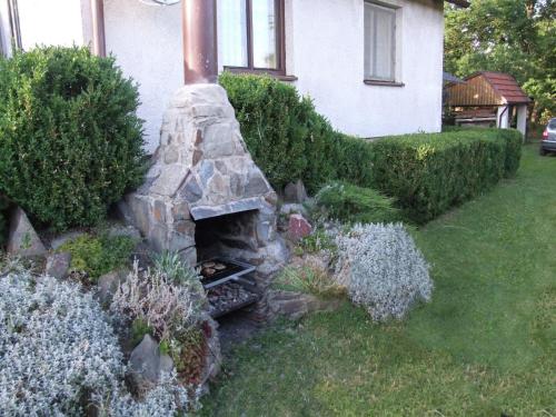 a stone oven in the yard of a house at Outdoor Adventure & Relaxation in Svinařov
