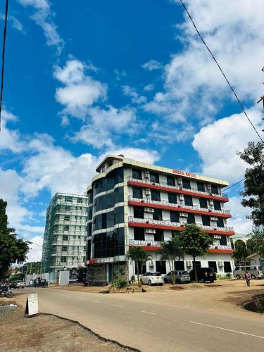 a tall building on the side of a street at Queen Hotel in Morogoro