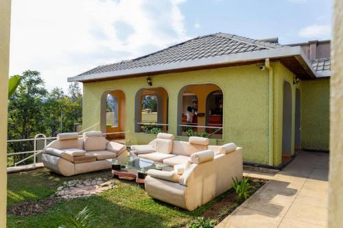 a backyard with couches and a gazebo at Emerald Villa Restaurant & Cafe in Kigali