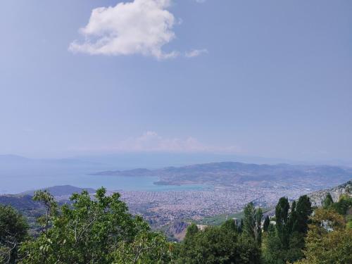 a view of a city and a lake from a mountain at Άνετος χώρος με parking, αυλή και θαυμάσια θέα in Makrinítsa