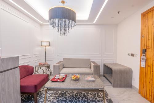 a living room with a chair and a table at Mastiff Select Mandavya Dharamkot, McLeodganj in Dharamshala