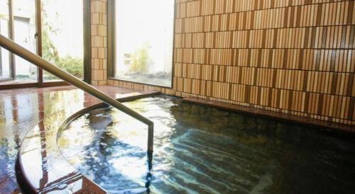 a large pool of water in a building at Ako Park Hotel in Ako