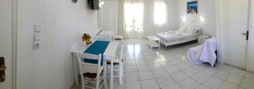 a kitchen and living room with a table and a couch at Limnionas Bay Village Hotel in Marathokampos