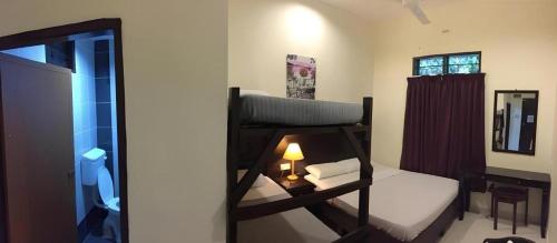 a bedroom with a bunk bed and a mirror at Perhentian Tivoli Inn in Perhentian Island