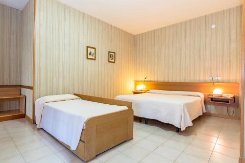 Ένα ή περισσότερα κρεβάτια σε δωμάτιο στο Hotel Residence Ulivi E Palme