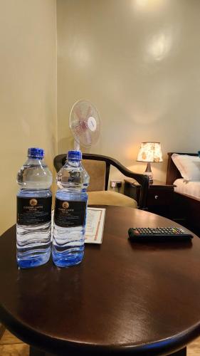 two bottles of water sitting on top of a table at Golden Castle Hotel Hoima in Hoima
