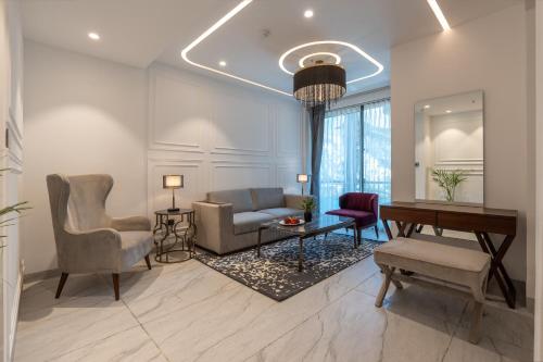 a living room with a couch and a table and chairs at Mastiff Select Mandavya Dharamkot, McLeodganj in Dharamshala