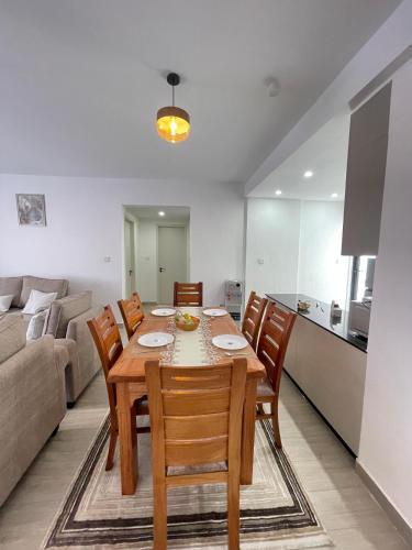 a kitchen and dining room with a table and chairs at Furnished 2-Bedroom Apartment with Swimming pool, Gym and Sauna in Gatunga