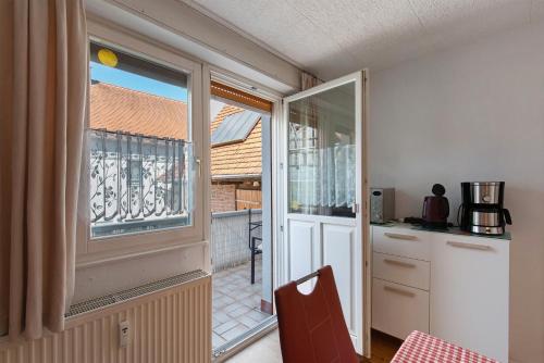 a kitchen with a sliding glass door to a balcony at Ferienhaus Alte Schäferei in Gründau