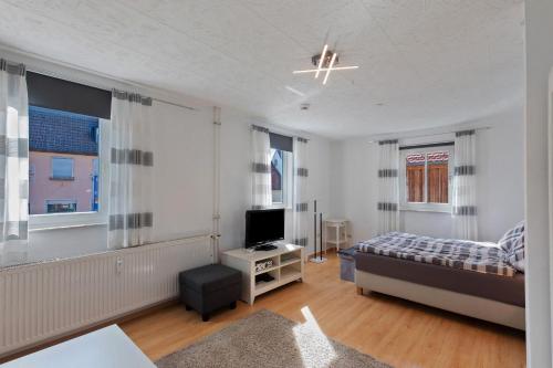 a bedroom with a bed and a television in it at Ferienhaus Alte Schäferei in Gründau