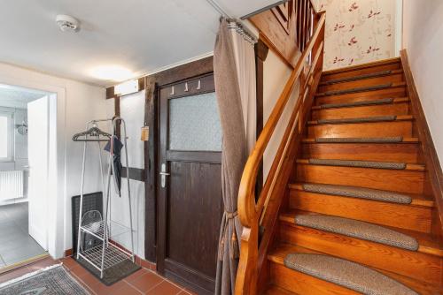 a wooden staircase with a wooden door in a house at Ferienhaus Alte Schäferei in Gründau