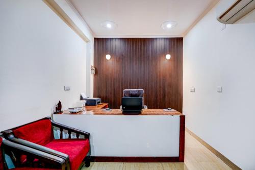 an office with a desk and a red chair at Maayra Inn in Noida
