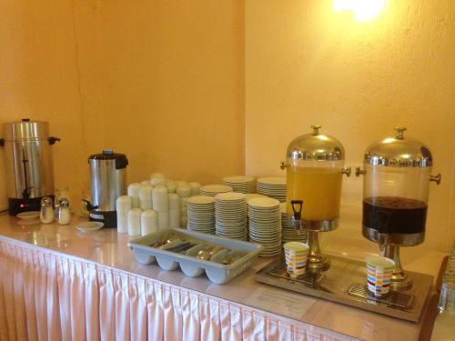 a counter with cups and plates and a coffee maker at Limnionas Bay Village Hotel in Marathokampos