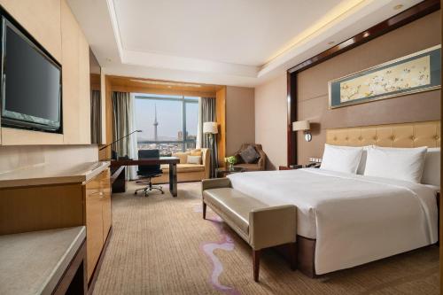 Ein Bett oder Betten in einem Zimmer der Unterkunft Wanda Realm Taizhou