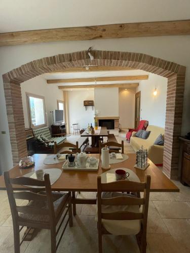 a dining room and living room with a table and chairs at Pasu B&B in Burgos