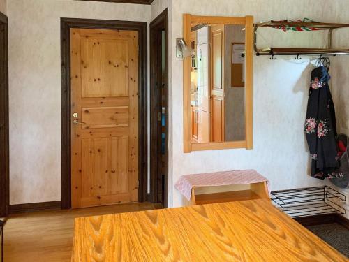 a room with a wooden door and a wooden table at 4 person holiday home in HOLSLJUNGA-By Traum in Holsljunga