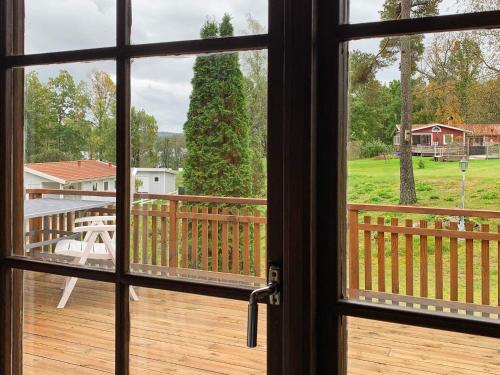 a view from a window of a deck with a tree at 4 person holiday home in HOLSLJUNGA-By Traum in Holsljunga