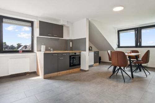 a kitchen and dining room with a table and chairs at Sali-Homes Monteur Stay in Kleve