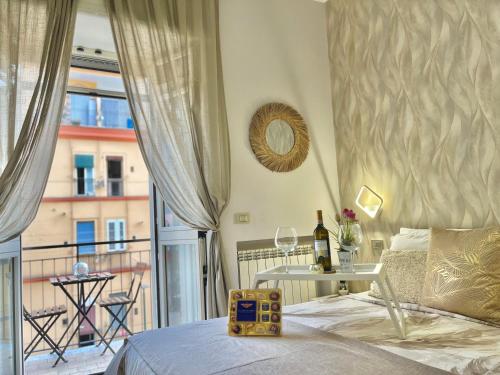 a bedroom with a bed and a window with a view at Mazzocchi House welcome wine in Naples