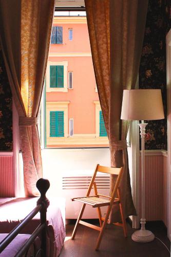 a chair sitting in front of a window at Casa Fanti 57 in Rome