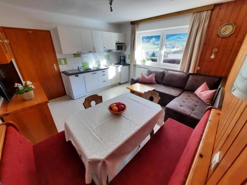 a small living room with a table and a couch at Appartement Schilcher in Oberau